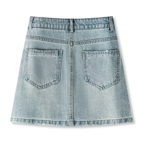Women's high-waisted, washed blue denim mini skirt with rhinestone details and frayed edges; versatile and stylish.